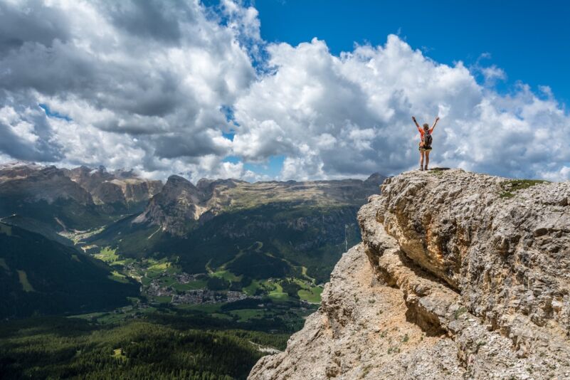 Person on tip of mountain cliff